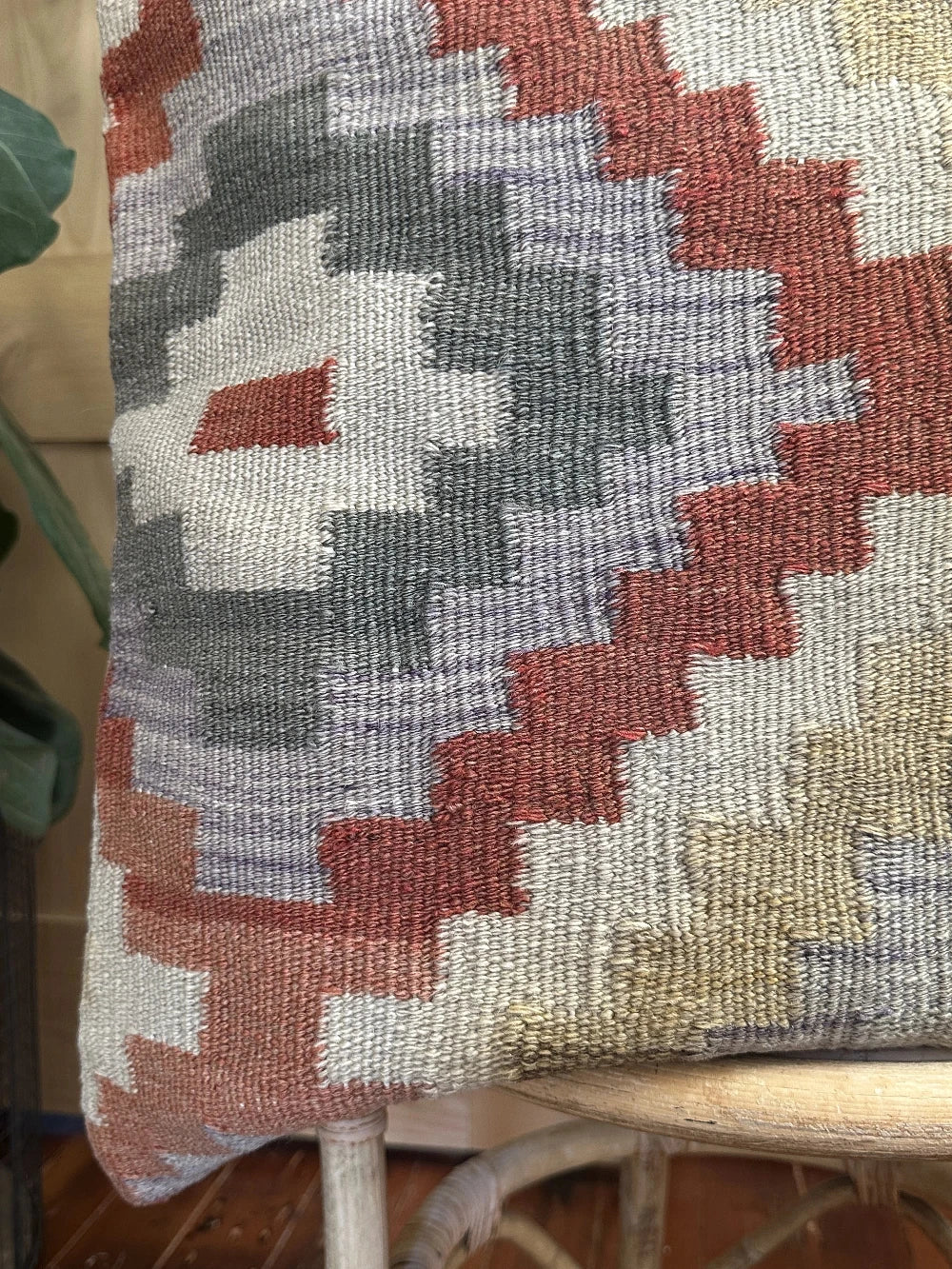 26 by 26 neutral geometric throw pillow featuring a zig-zag colorful pattern throughout
