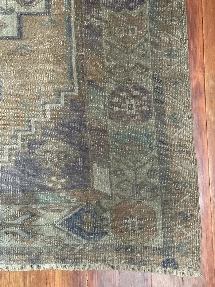 4 by 7 neutral Turkish area rug featuring a beautiful floral border and pops of lavendar and sky blue.