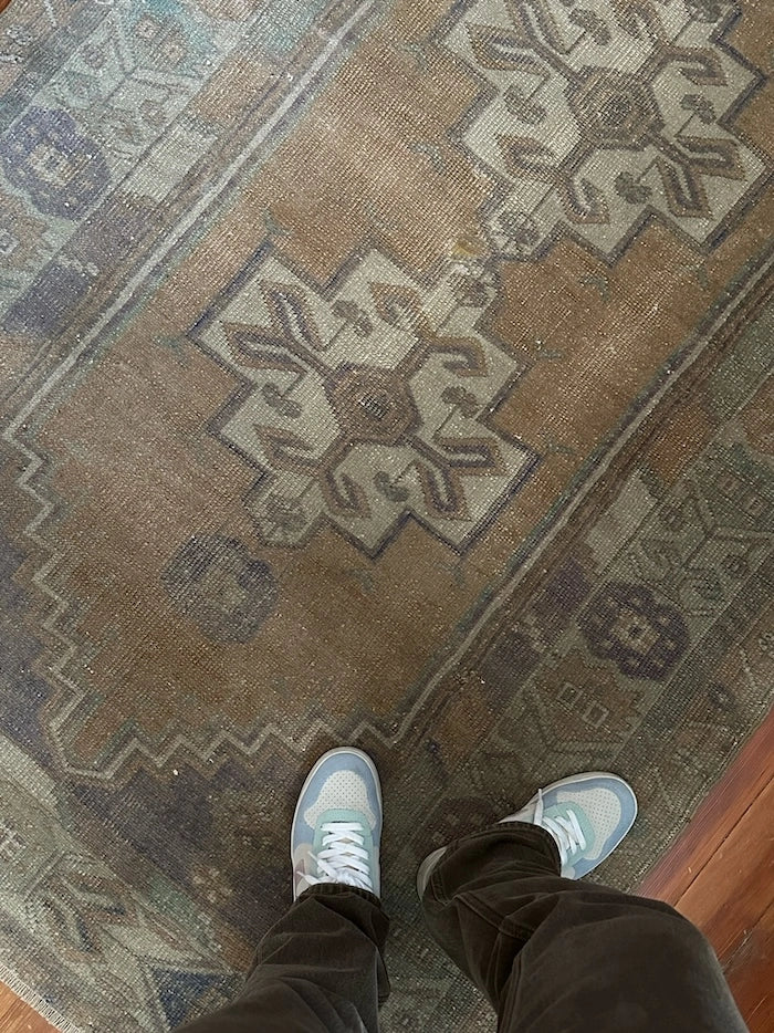 4 by 7 neutral Turkish area rug featuring a beautiful floral border and pops of lavendar and sky blue.