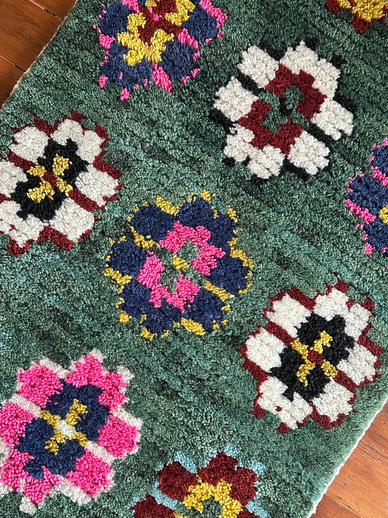 Colorful floral-patterned rug on a wooden floor