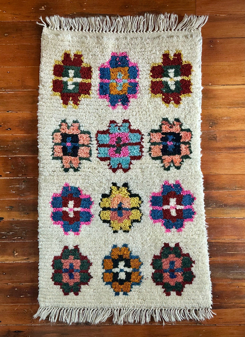 Decorative rug with floral pattern on a wooden floor