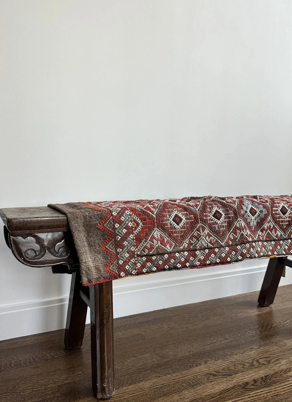 Mini Turkish Rug featuring pops of red and light blue with a repeating diamond pattern throughout