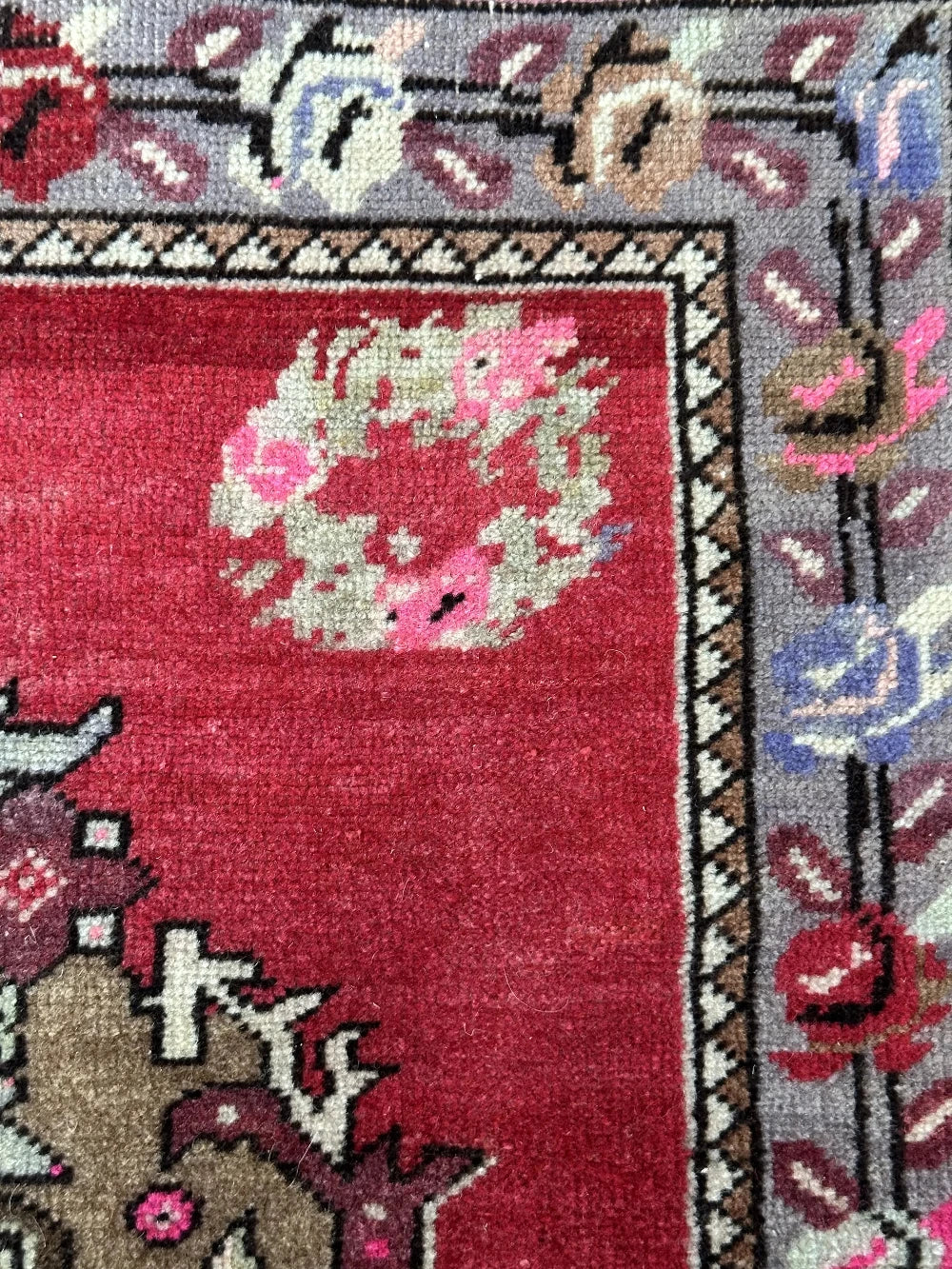 square mini red Turkish rug with a rose patterned border and large geometric medallion center