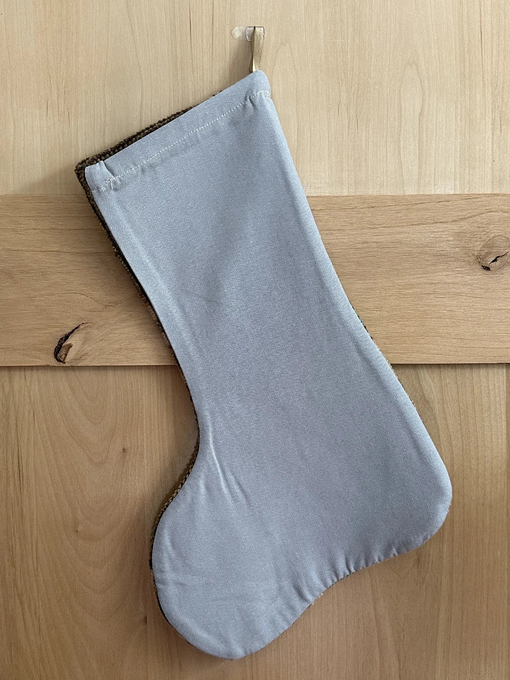 handmade Turkish rug Christmas stocking featuring a neutral floral pattern with hints of baby blue flowers