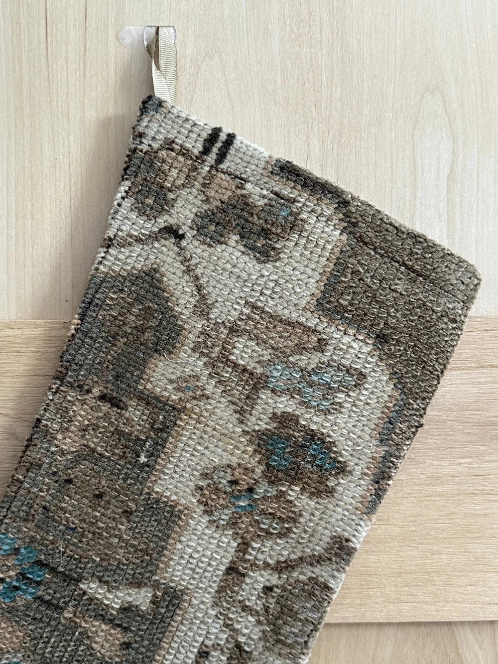 handmade Turkish rug Christmas stocking featuring a neutral floral pattern with hints of baby blue flowers