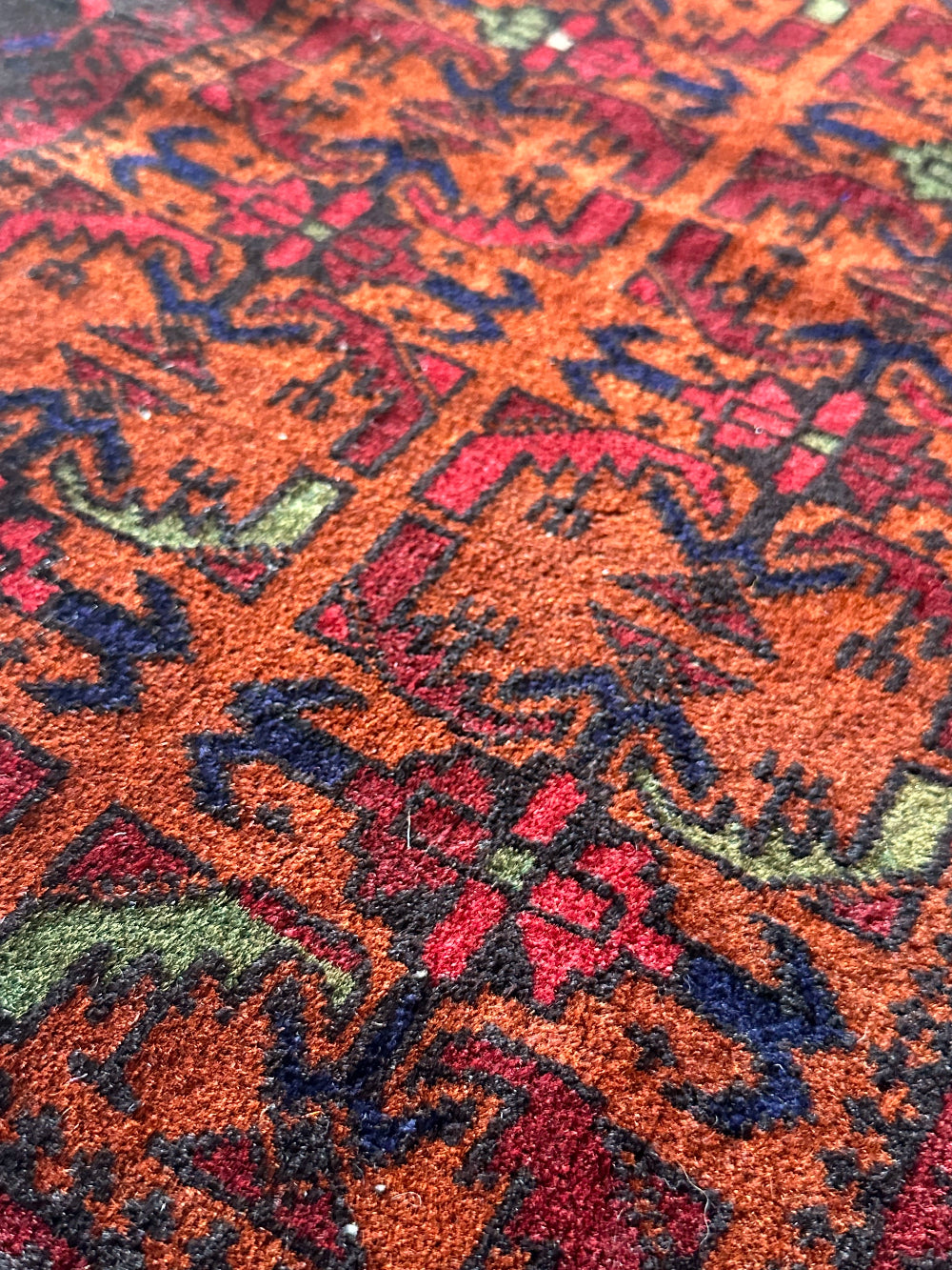 Decorative rug with intricate patterns on a wooden floor