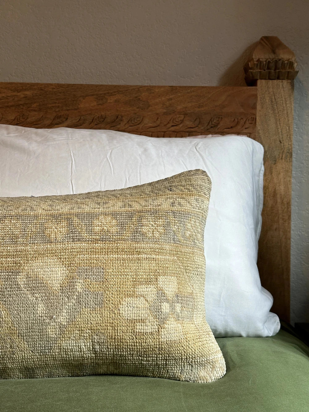 12 by 36 neutral lumbar pillow featuring a geometric design and hints of lilac, tan and sand.