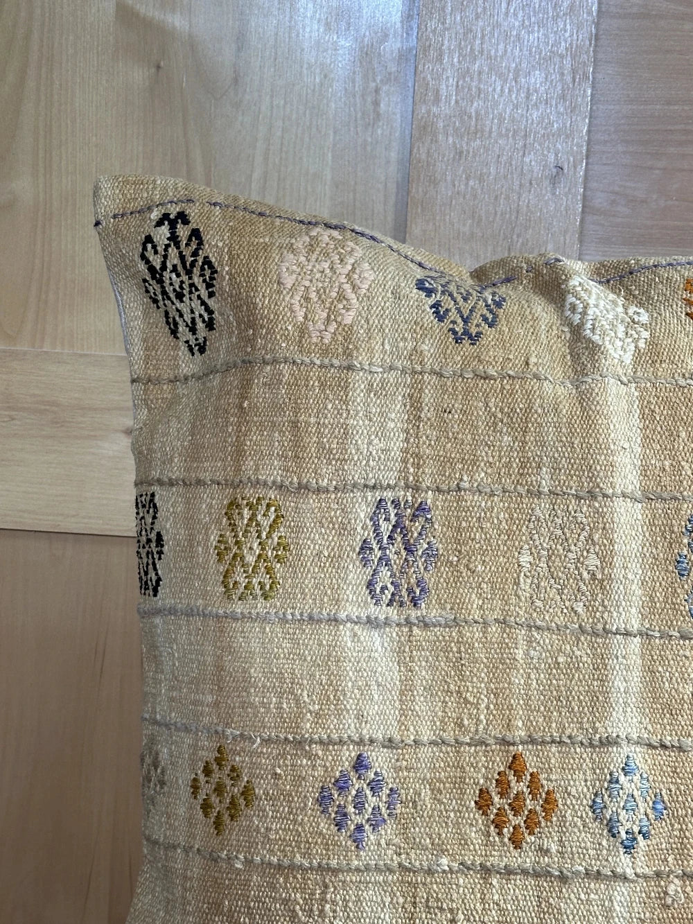 26 by 26 tan plaid turkish pillow that also doubles as a floor cushion with multi-colored floral embroidery