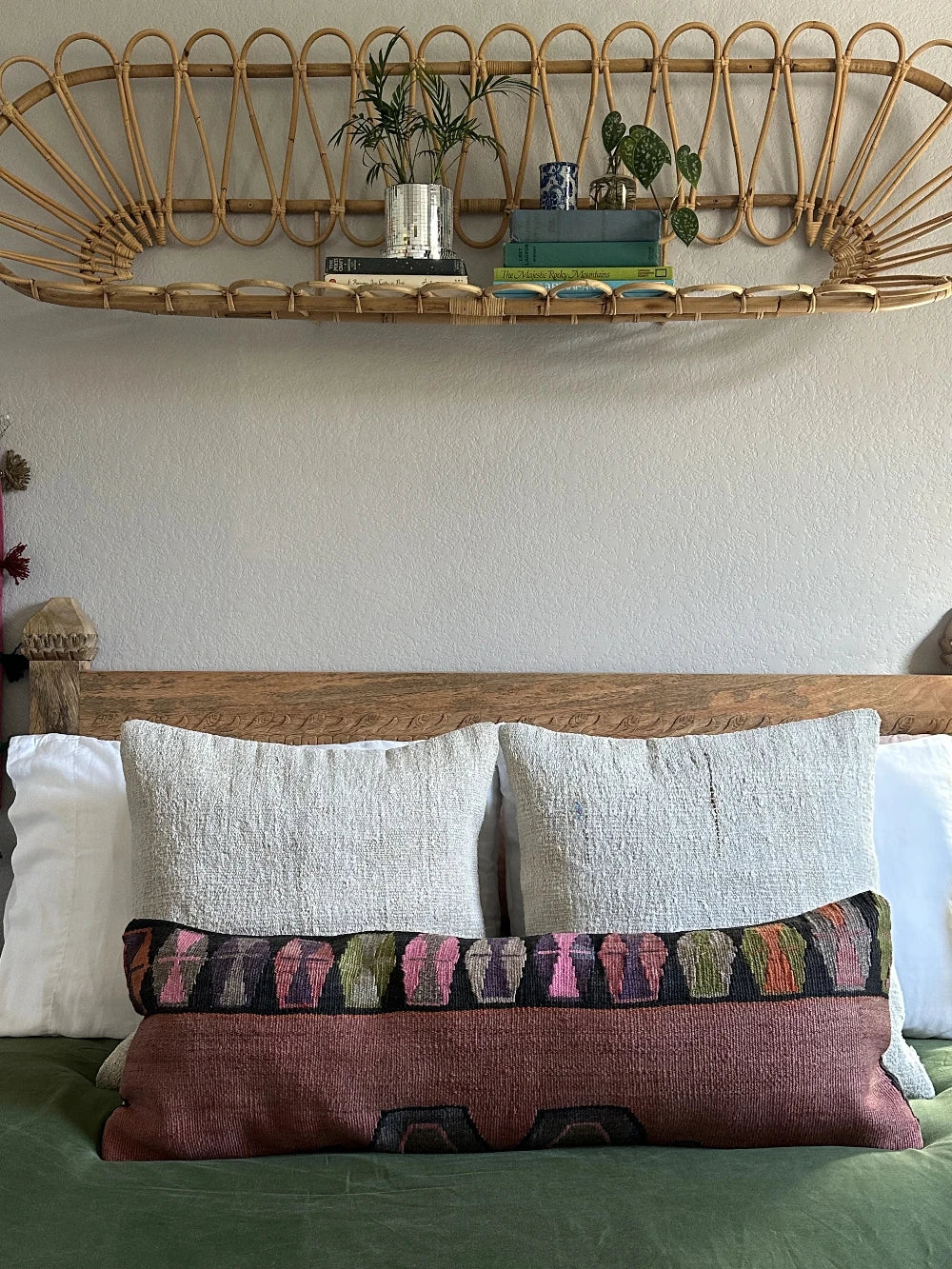 12 by 36 colorful turkish lumbar pillow featuring an all over merlot coloring and a geometric multi-colored band at the top with pops of pink, purple, green and orange