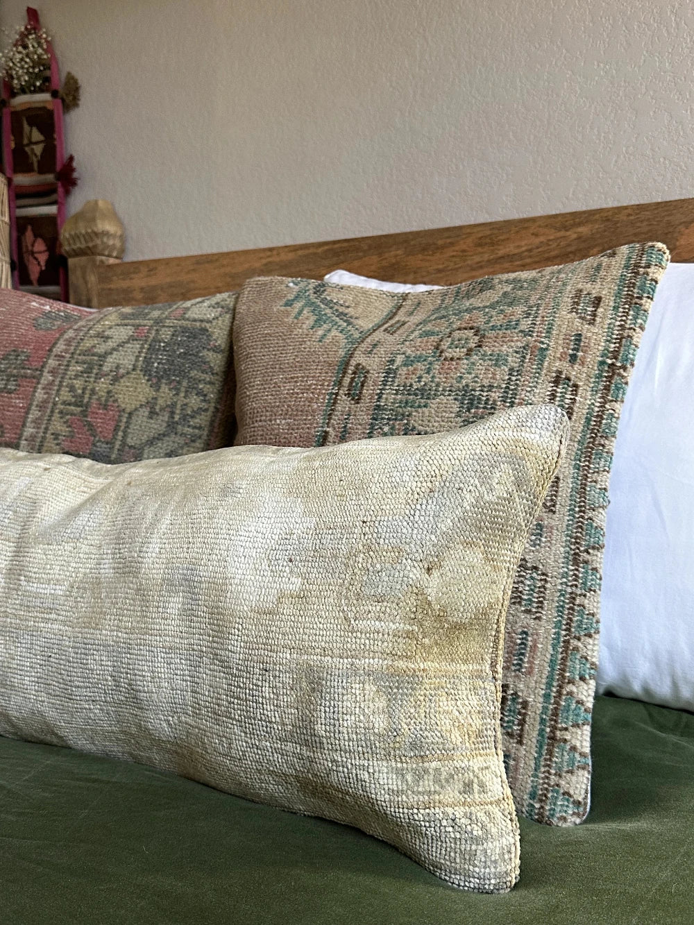 12 by 36 neutral lumbar pillow featuring a geometric design and hints of lilac, tan and sand.
