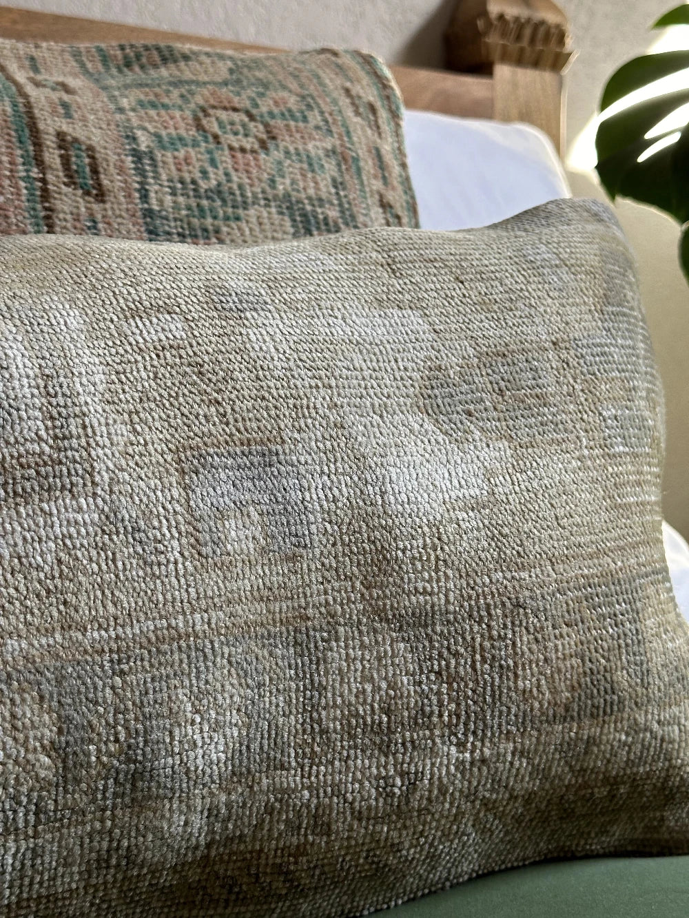12 by 36 neutral lumbar pillow featuring a geometric design and hints of lilac, tan and sand.