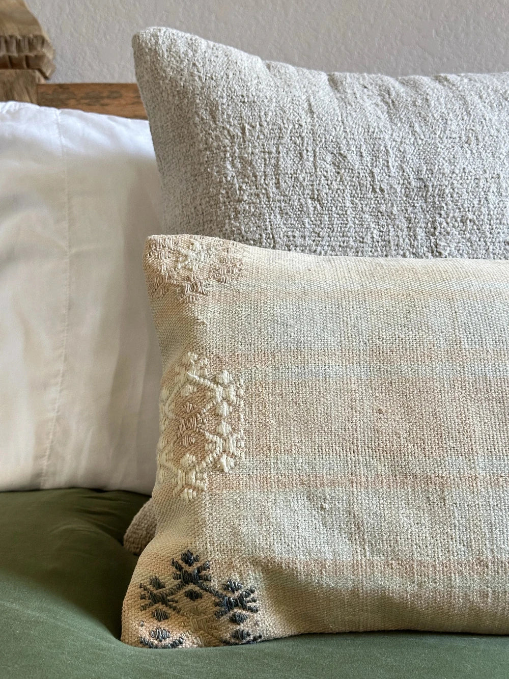 12 by 36 neutral lumbar pillow featuring light yellow and blue plaid and colorful floral embroidery throughout