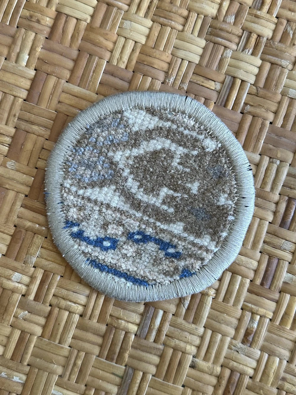 Handmade, unique 5 inch diameter turkish rug coaster set featuring navy and gold coloring and geometric pattern