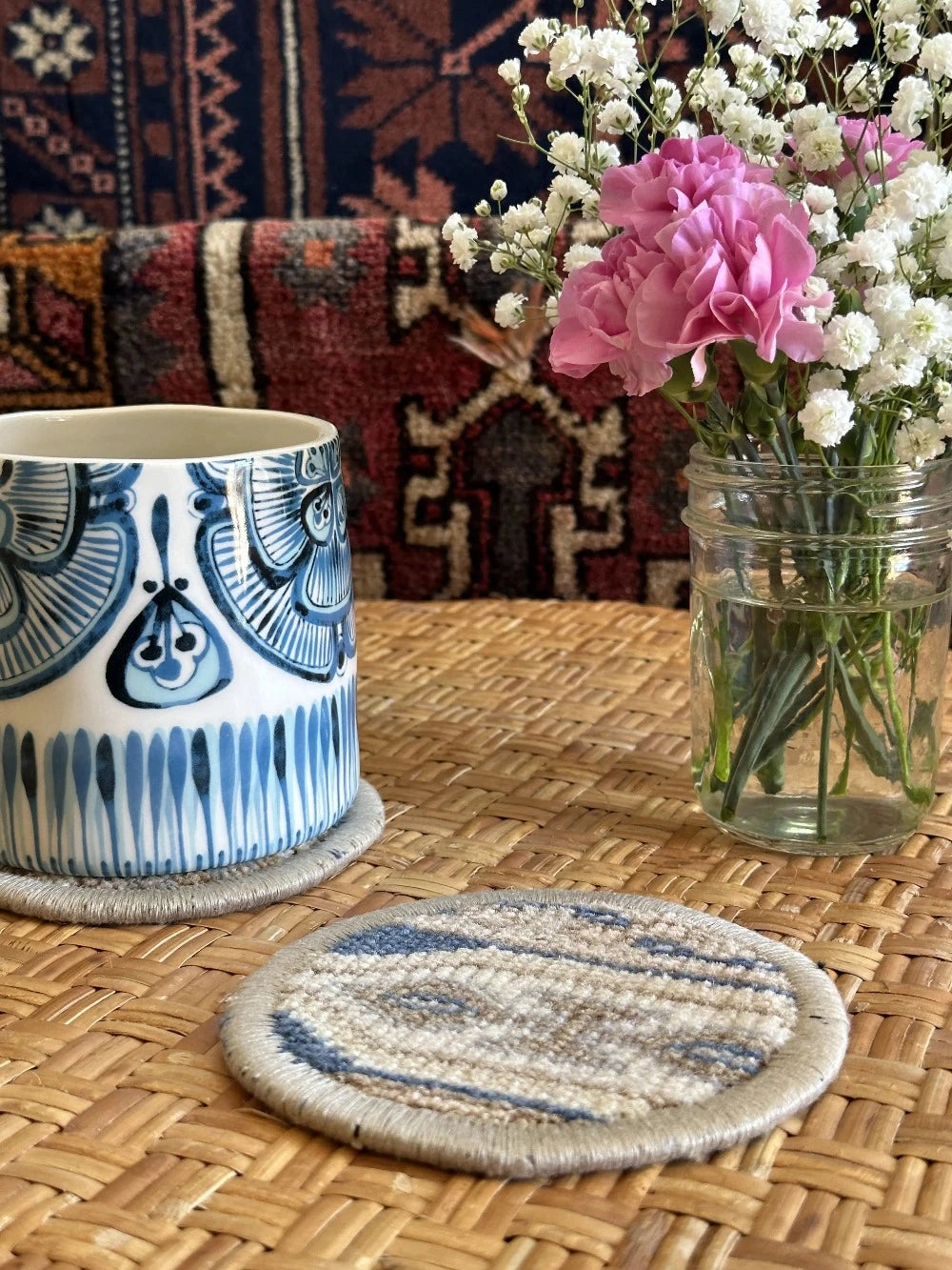 Handmade, unique 5 inch diameter turkish rug coaster set featuring navy and gold coloring and geometric pattern