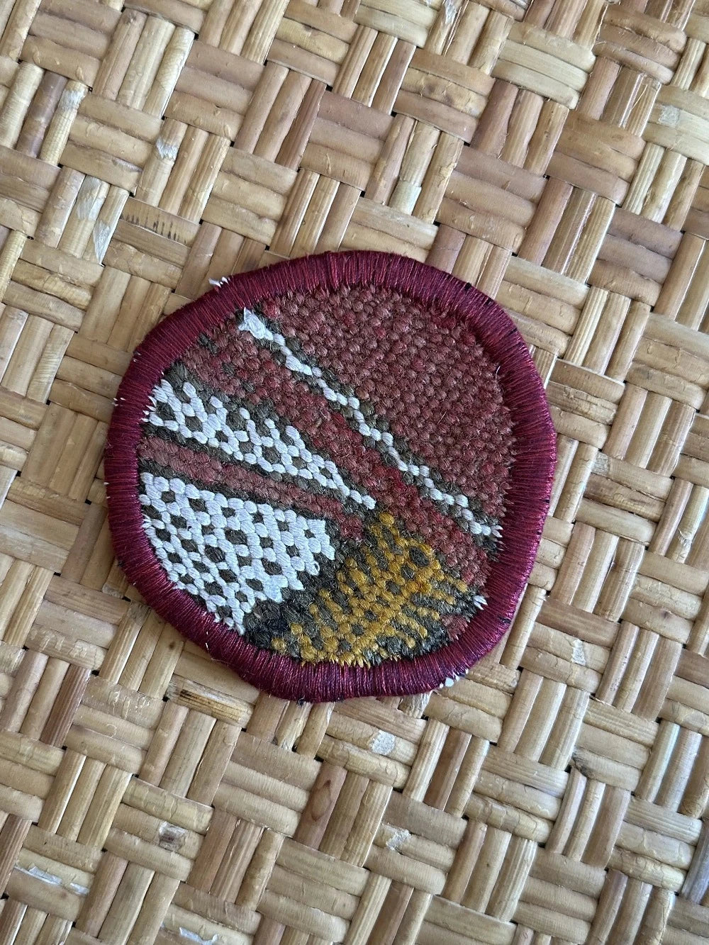 Turkish coaster set measuring 3.75 inches featuring a white and orange geometric print