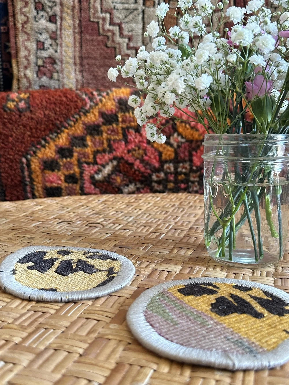 Upcycled Turkish coaster fabric coaster set featuring a colorful and geometric floral pattern measuring 3.75 inches