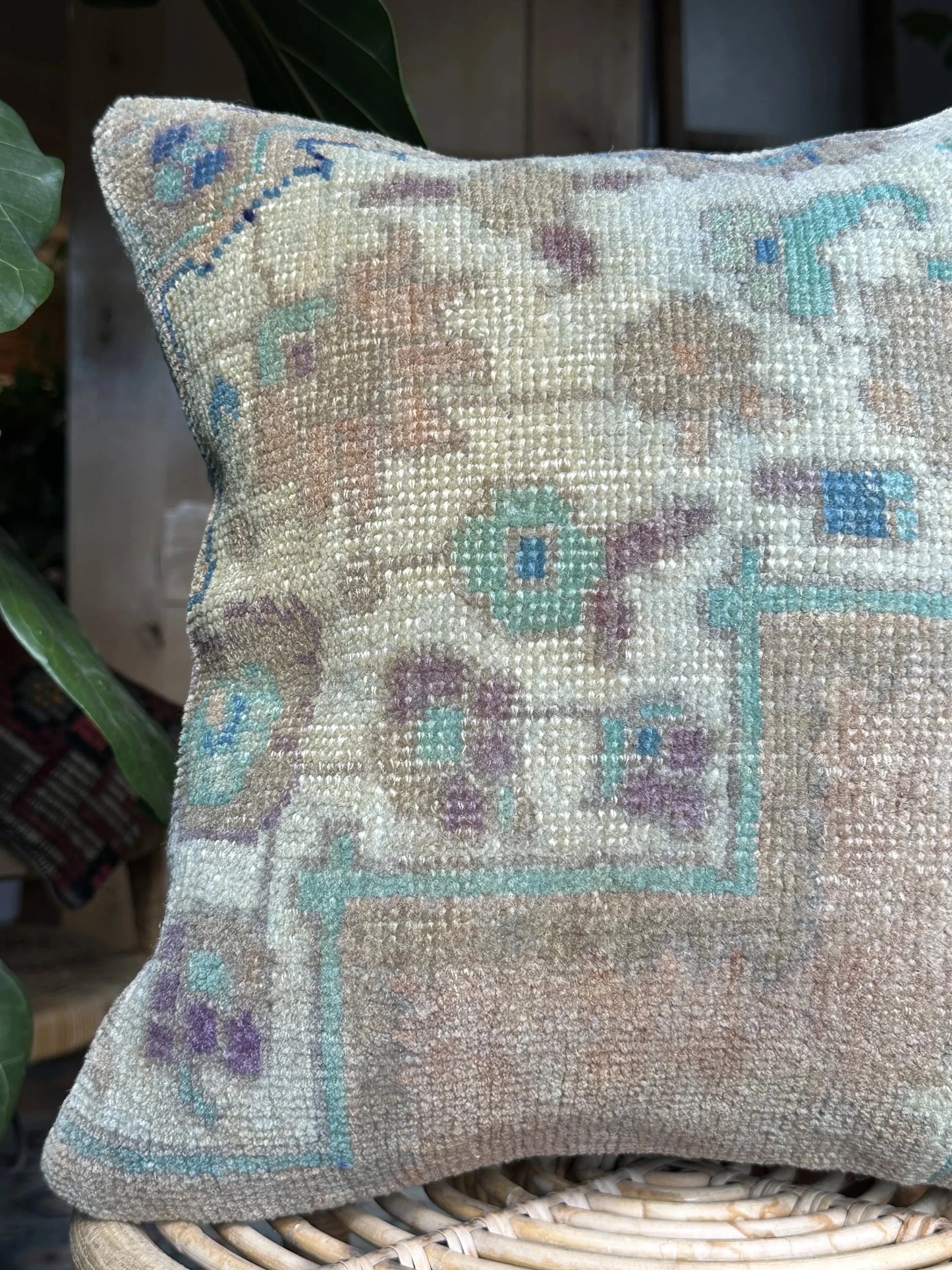 15 by 15 neutral Turkish throw pillow featuring soft pile and muted blue and white tones and a floral pattern upcycled from a Turkish rug