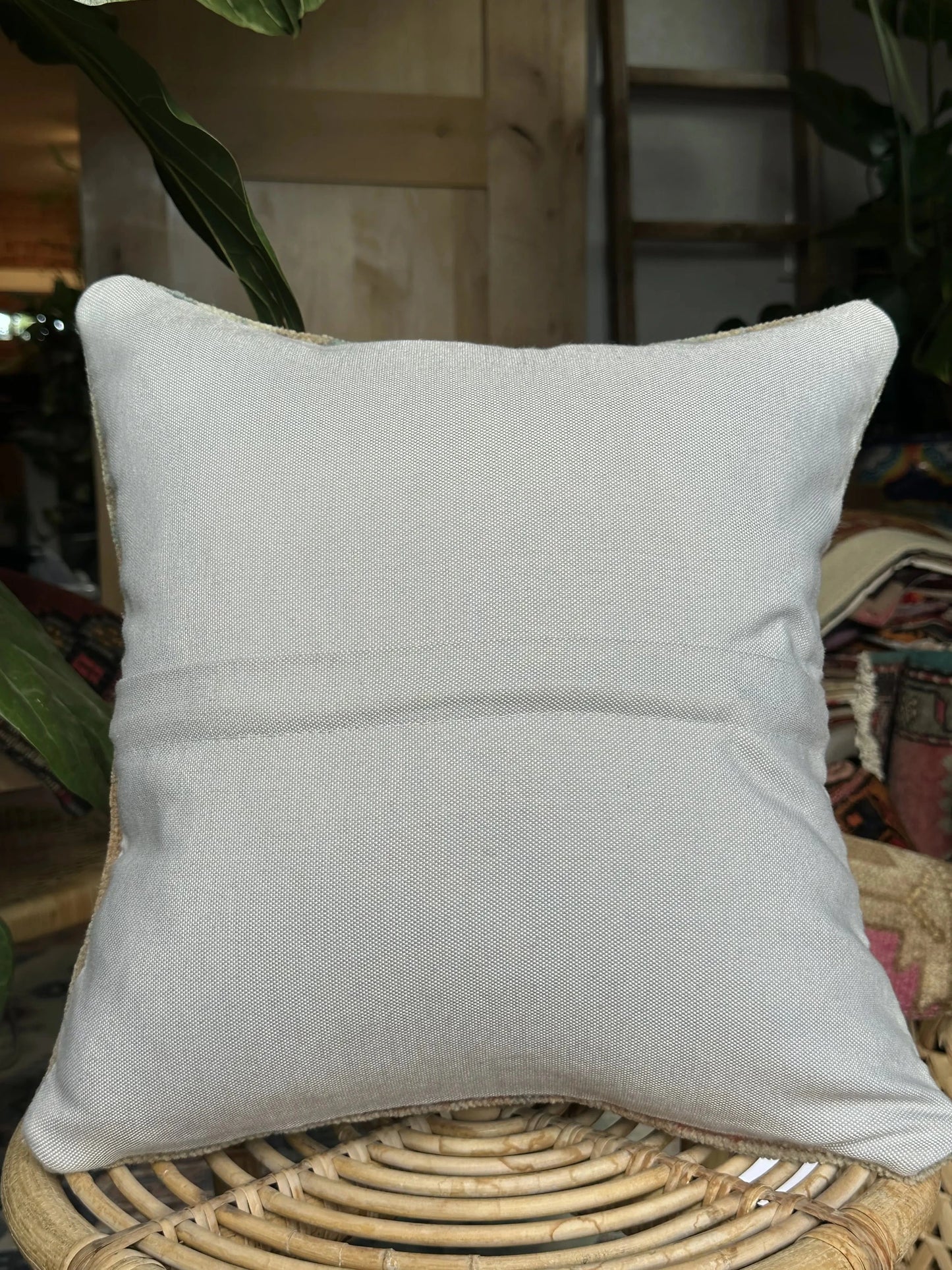 15 by 15 neutral Turkish throw pillow featuring soft pile and muted blue and white tones and a floral pattern upcycled from a Turkish rug