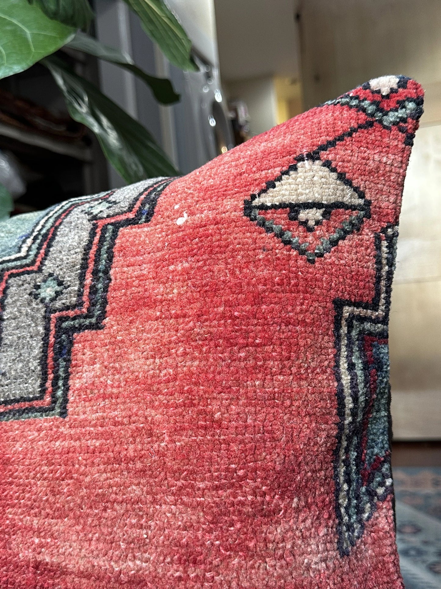 16 by 24 Turkish lumbar pillow featuring bright red coloring and accents of emerald and gold upcycled from a Turkish rug