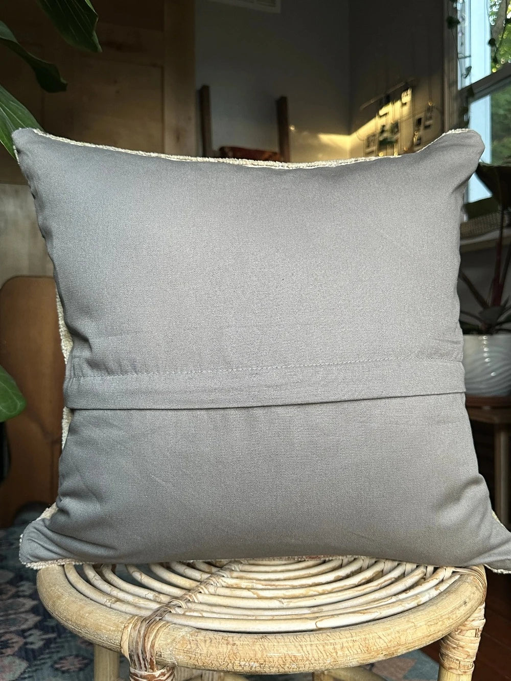 18 by 18 neutral Turkish pillow made from old Turkish rugs, light red and pink coloring throughout but mostly white and light sand
