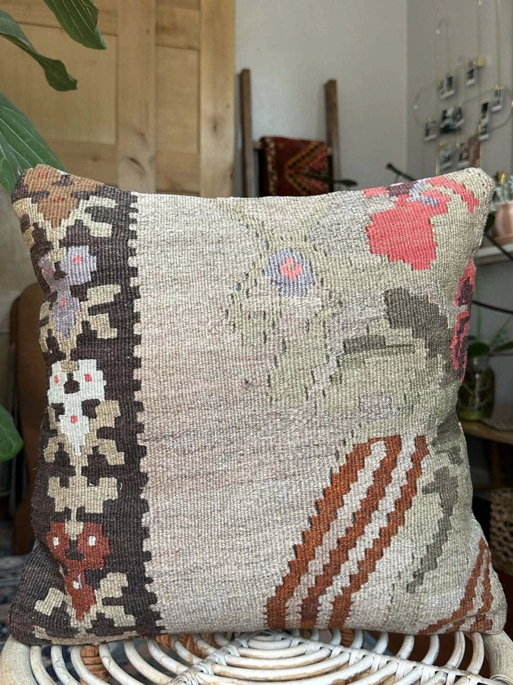 16 by 16 neutral Turkish pillow featuring a tan and brown colorway with pops of color in the form of geometric looking flowers