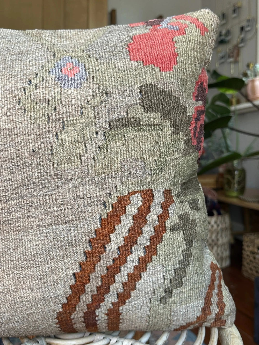 16 by 16 neutral Turkish pillow featuring a tan and brown colorway with pops of color in the form of geometric looking flowers