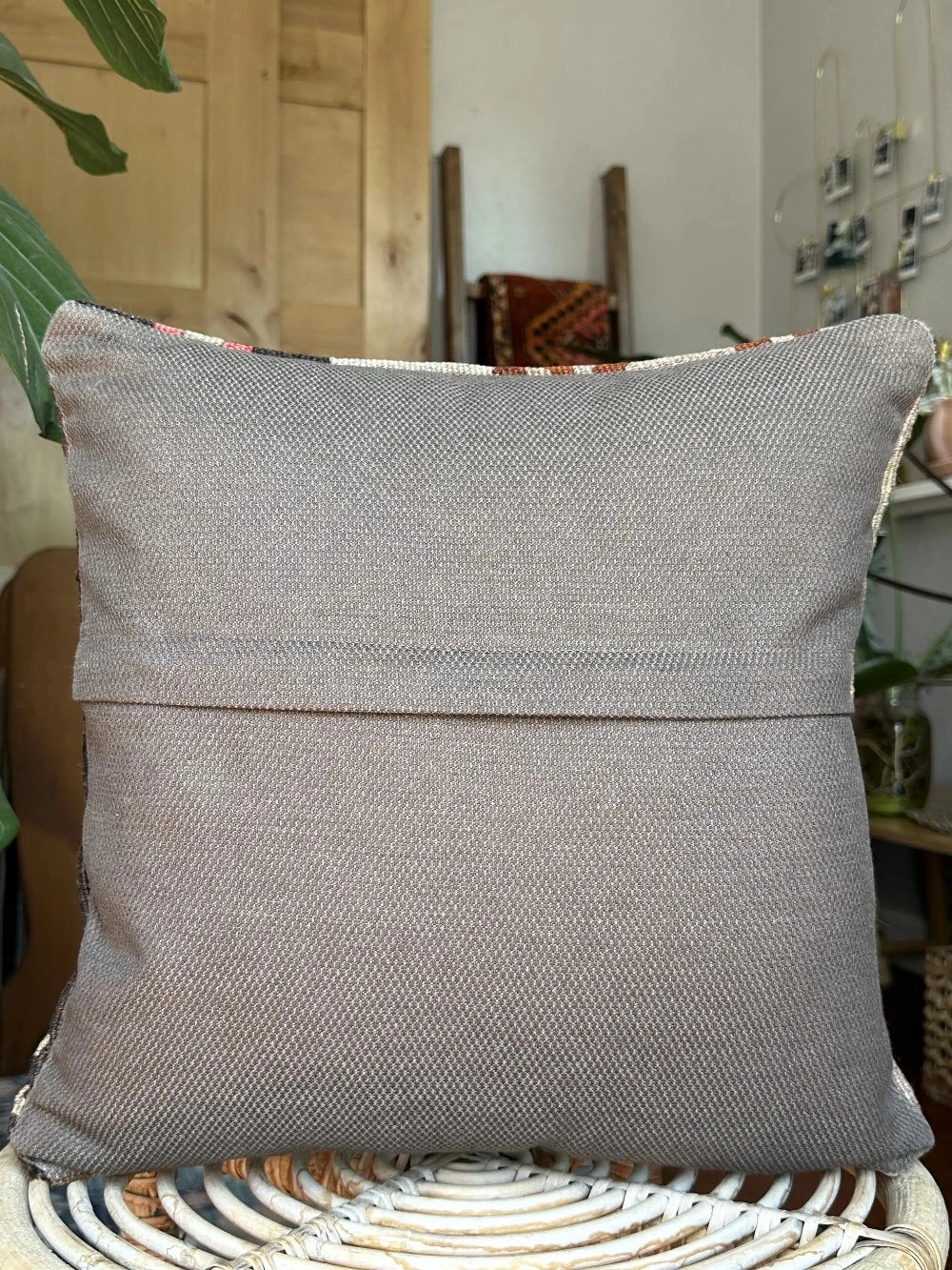 16 by 16 neutral Turkish pillow featuring a tan and brown colorway with pops of color in the form of geometric looking flowers