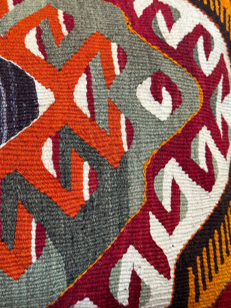 16 by 24 Decorative pillow with geometric pattern on a wooden stool indoors