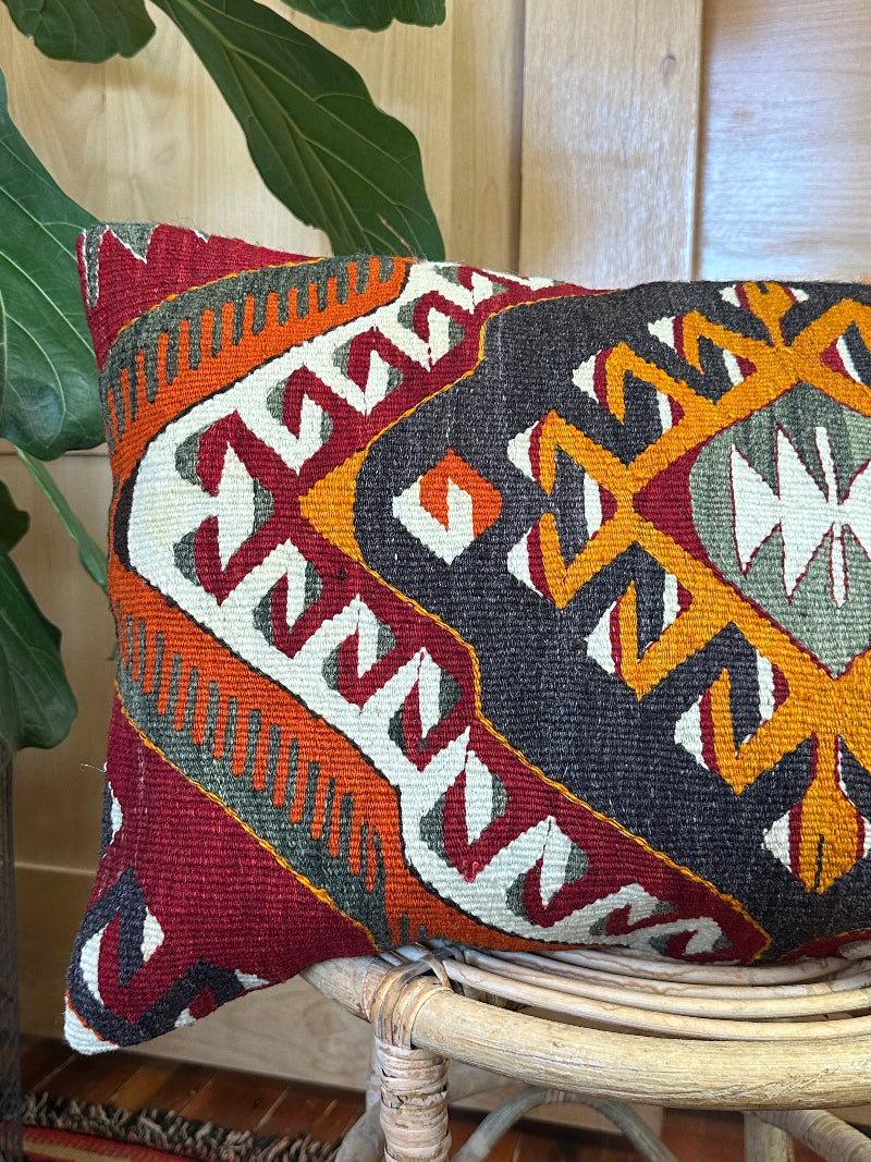 Decorative pillow with geometric pattern on a chair