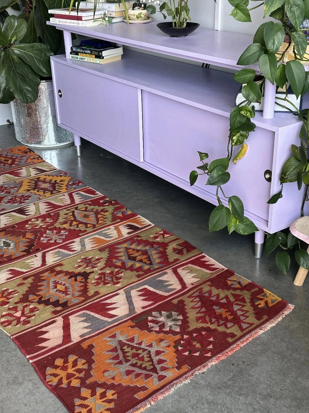 6 by 2.5 small colorful Turkish kilim runner featuring multicolored stripes around 12 inches wide and many different geometric patterns throughout
