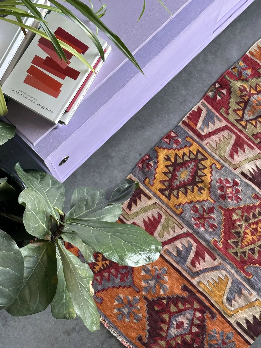 6 by 2.5 small colorful Turkish kilim runner featuring multicolored stripes around 12 inches wide and many different geometric patterns throughout