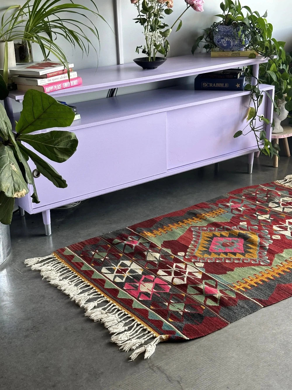5.5 by 2.9 foot colorful Turkish area rug featuring diamond geometric patterns and bright accent colors