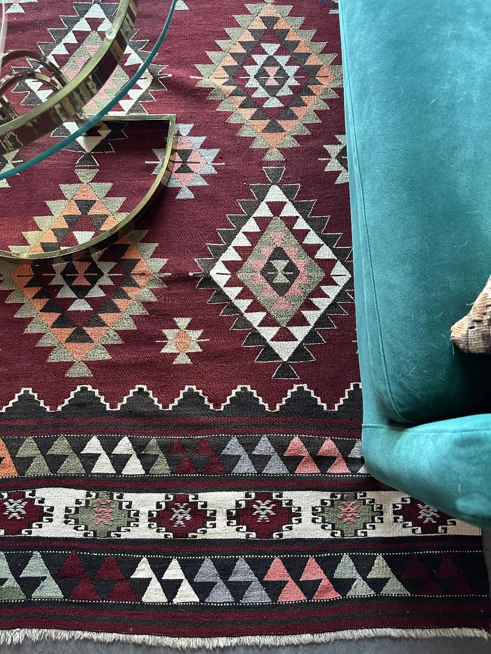 8 by 5 foot large red Turkish kilim area rug featuring large diamond medallions in the center and multiple striped borders around the outside
