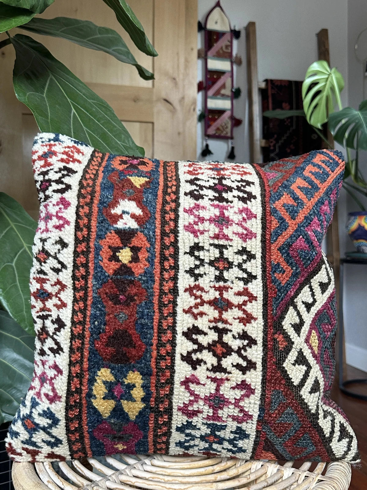 16 x 16 handmade Turkish throw pillow featuring geometric patterns throughout and dark navy and purple coloring with cream accent
