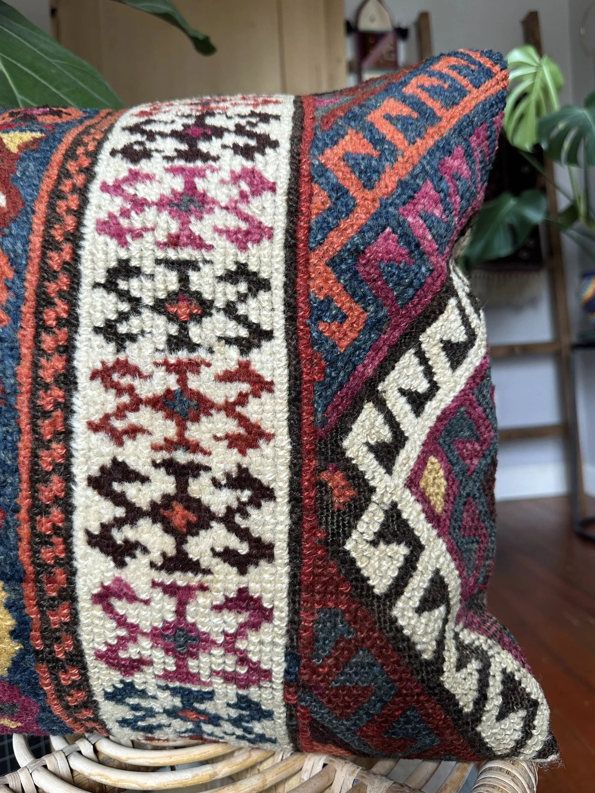 16 x 16 handmade Turkish throw pillow featuring geometric patterns throughout and dark navy and purple coloring with cream accent