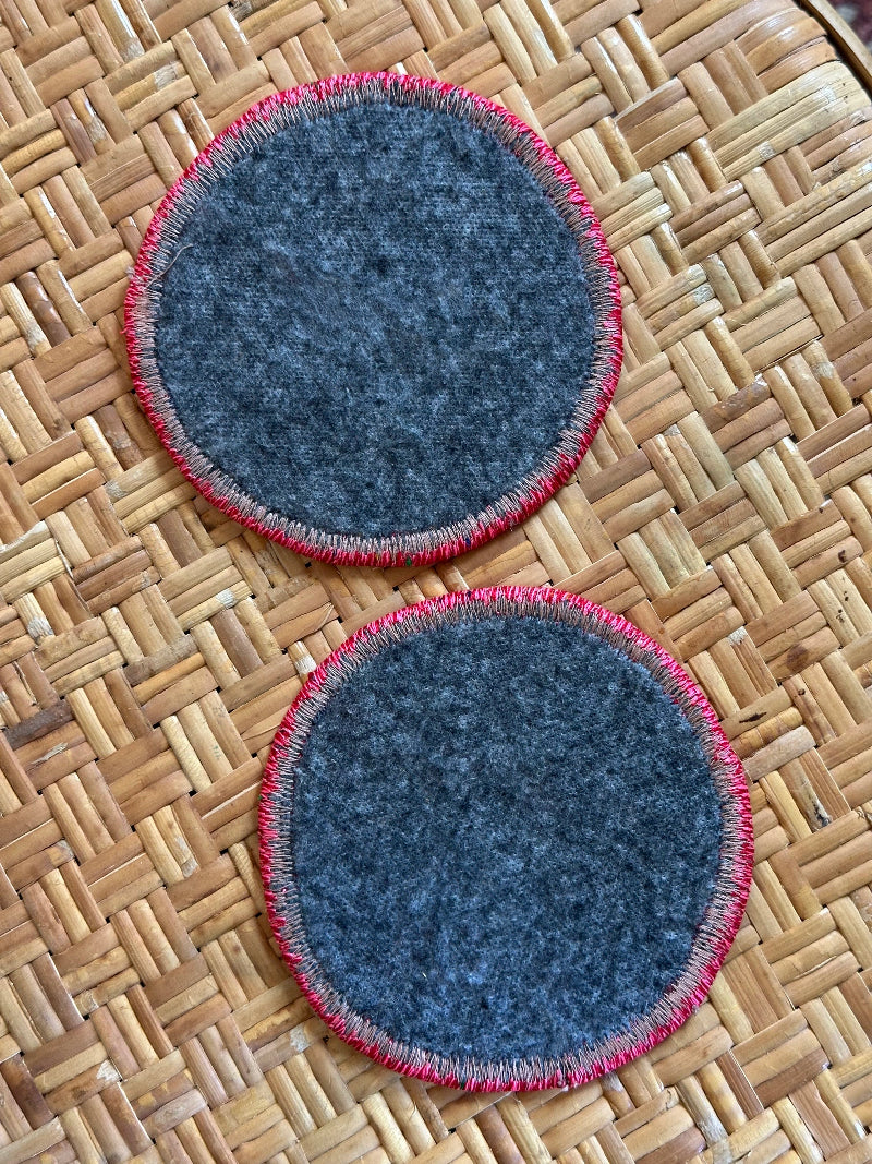 Handmade Turkish rug coasters with pink trim, repurposed from vintage rugs for a unique, sustainable home decor accent