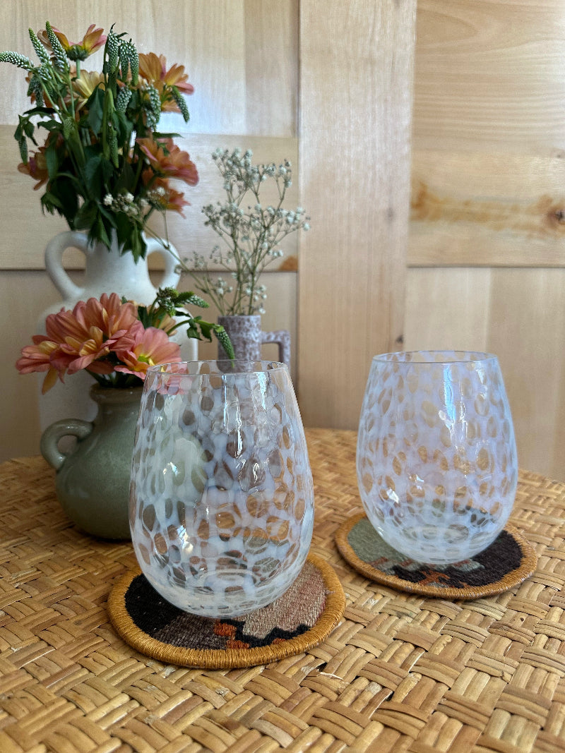 Handmade Turkish rug coasters with orange trim, repurposed from vintage rugs for a unique, sustainable home decor accent