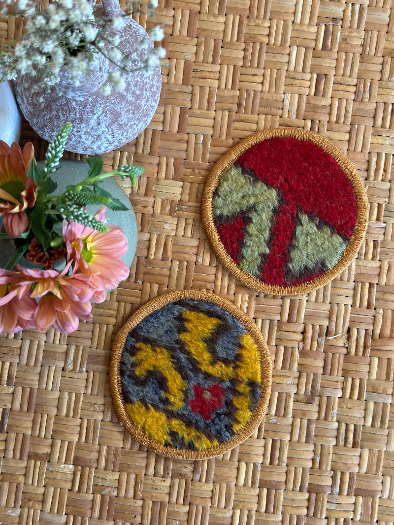 Handmade Turkish rug coasters with orange trim, repurposed from vintage rugs for a unique, sustainable home decor accent