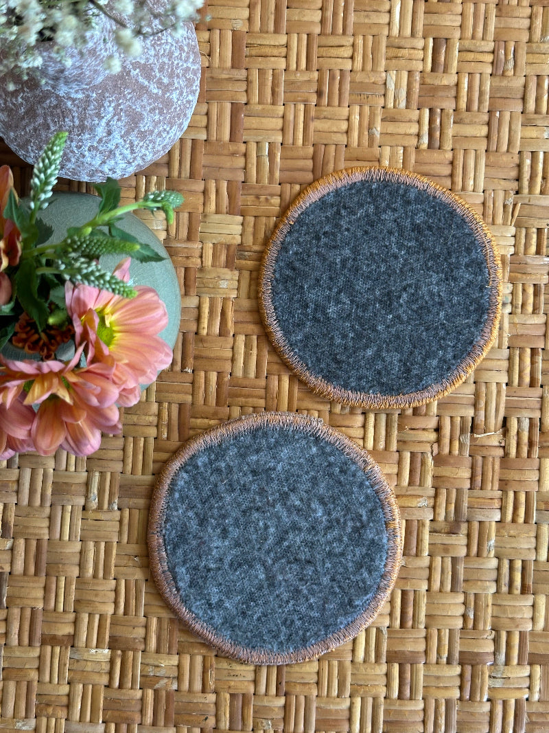 Handmade Turkish rug coasters with orange trim, repurposed from vintage rugs for a unique, sustainable home decor accent