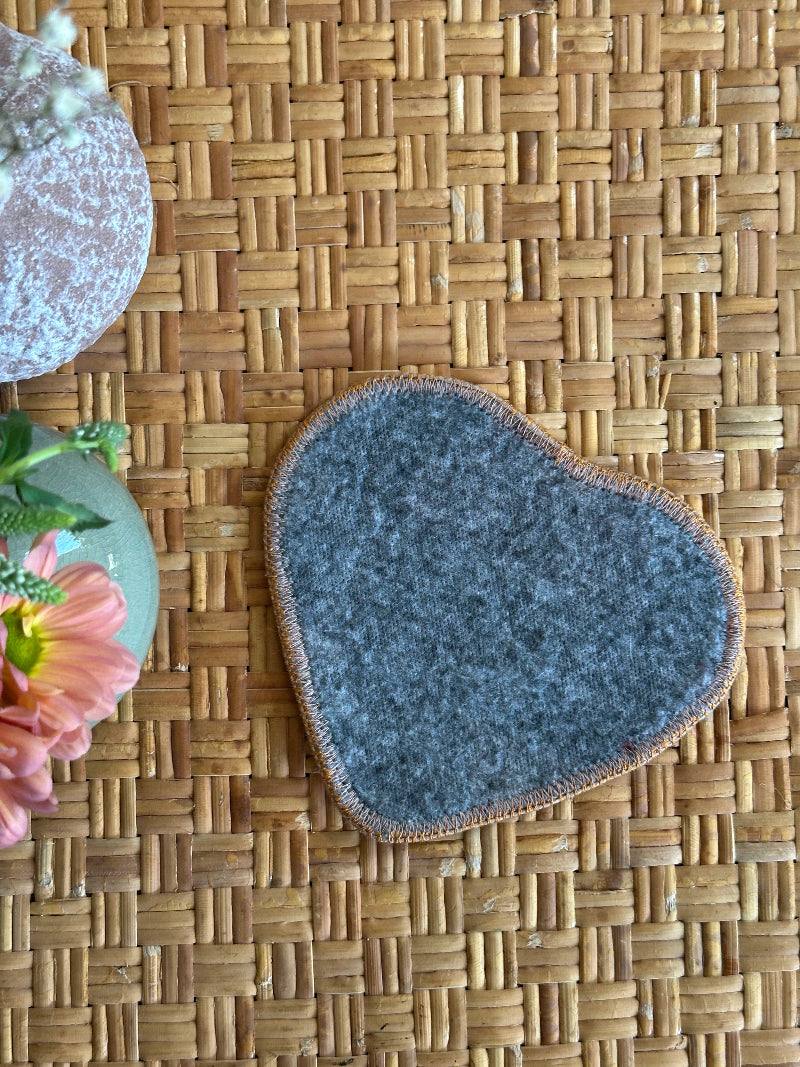 Heart-shaped Turkish rug hot plate with neutral tones and geometric patterns, handcrafted from repurposed vintage rugs for a unique, sustainable home accent