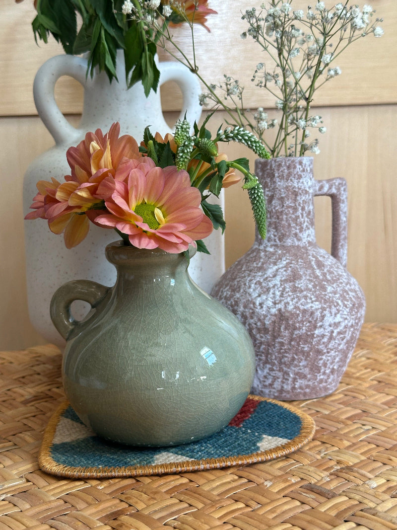 Heart-shaped Turkish rug hot plate made from repurposed vintage rugs with earthy tones and embroidered trim, perfect for teapots, plants, or decor