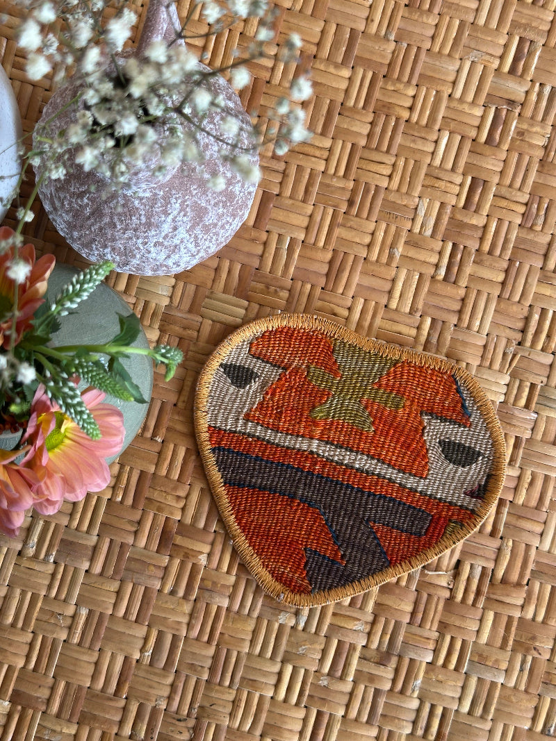 Heart-shaped Turkish rug hot plate with bold red and navy geometric patterns, handcrafted from repurposed vintage rugs for a unique, sustainable home accent