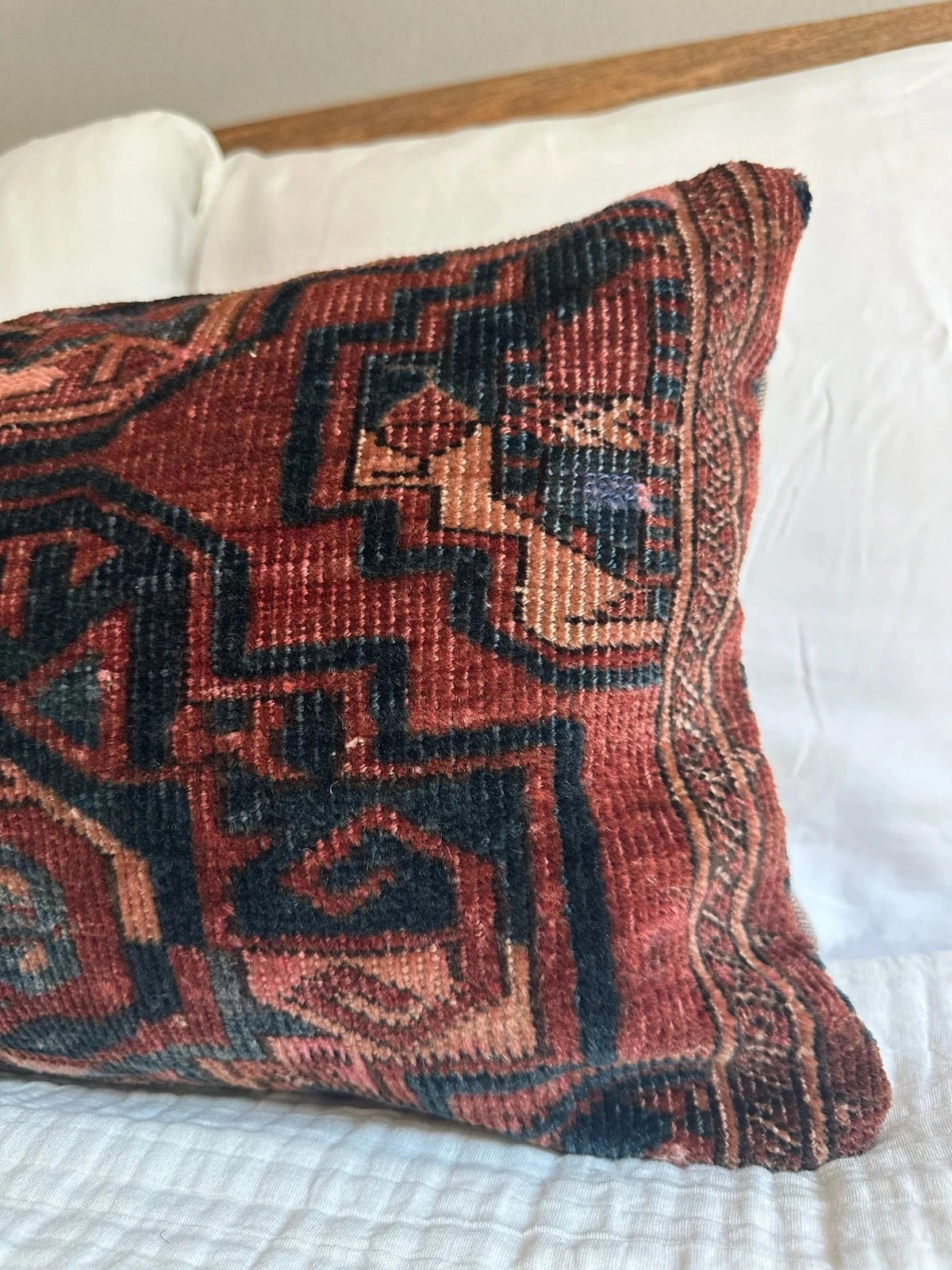 12 by 24 inch handmade Turkish lumbar pillows featuring a velvety soft pile and merlot red, pink and navy color palette.