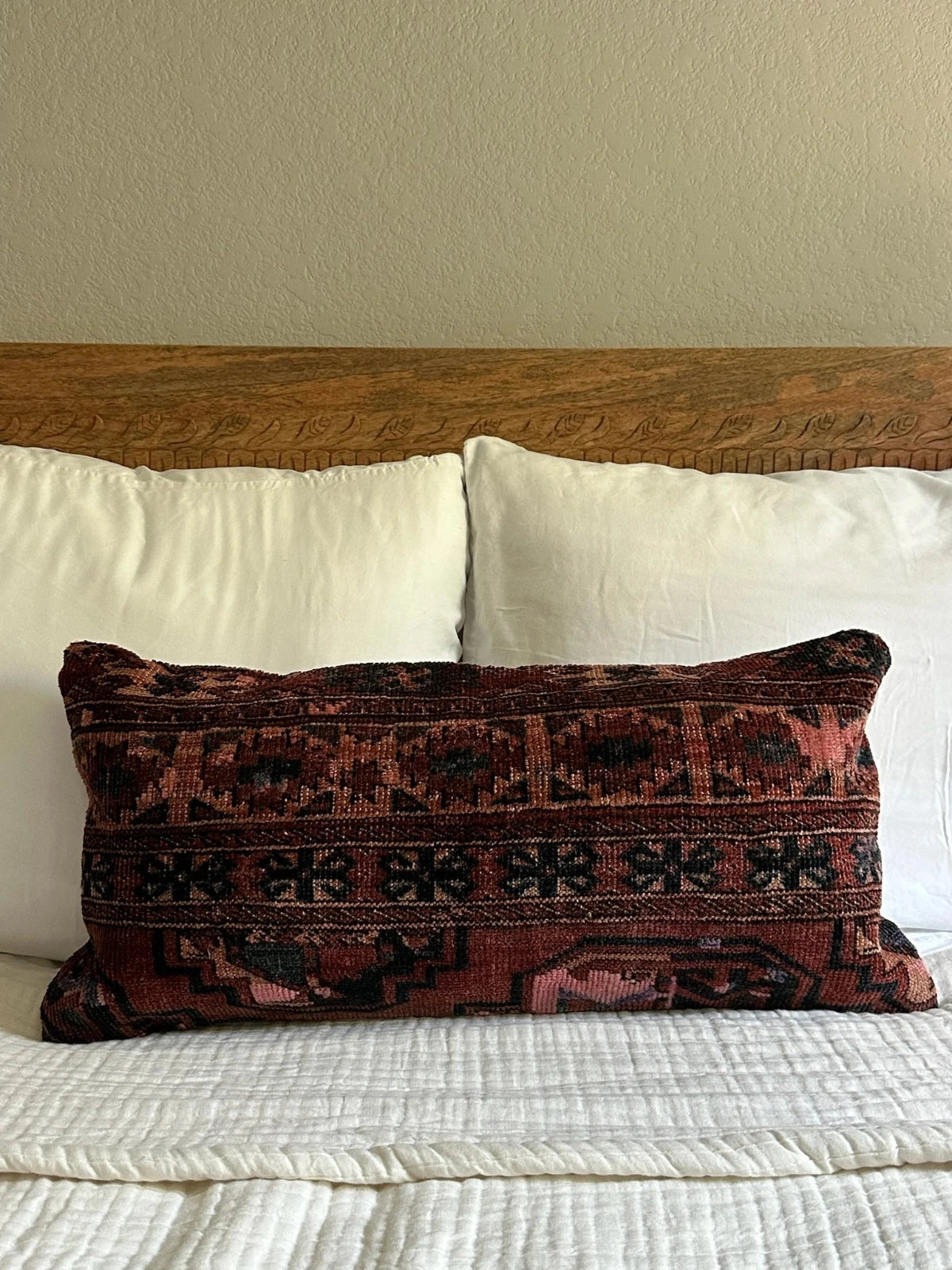 12 by 24 inch handmade Turkish lumbar pillows featuring a velvety soft pile and merlot red, pink and navy color palette.