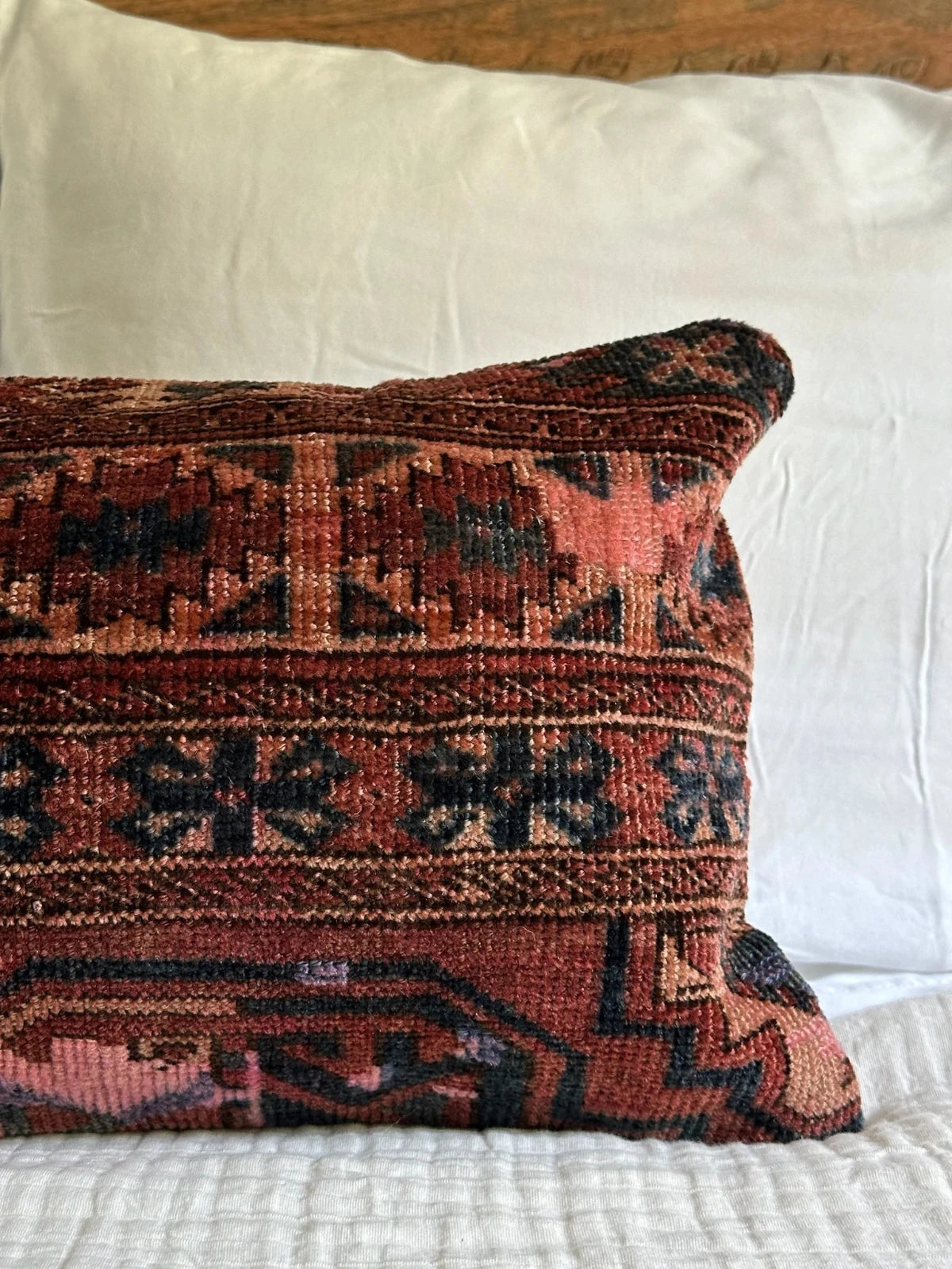 12 by 24 inch handmade Turkish lumbar pillows featuring a velvety soft pile and merlot red, pink and navy color palette.