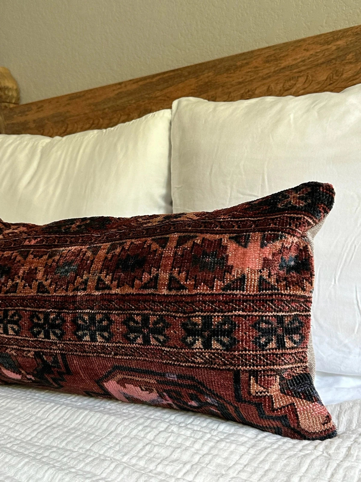 12 by 24 inch handmade Turkish lumbar pillows featuring a velvety soft pile and merlot red, pink and navy color palette.
