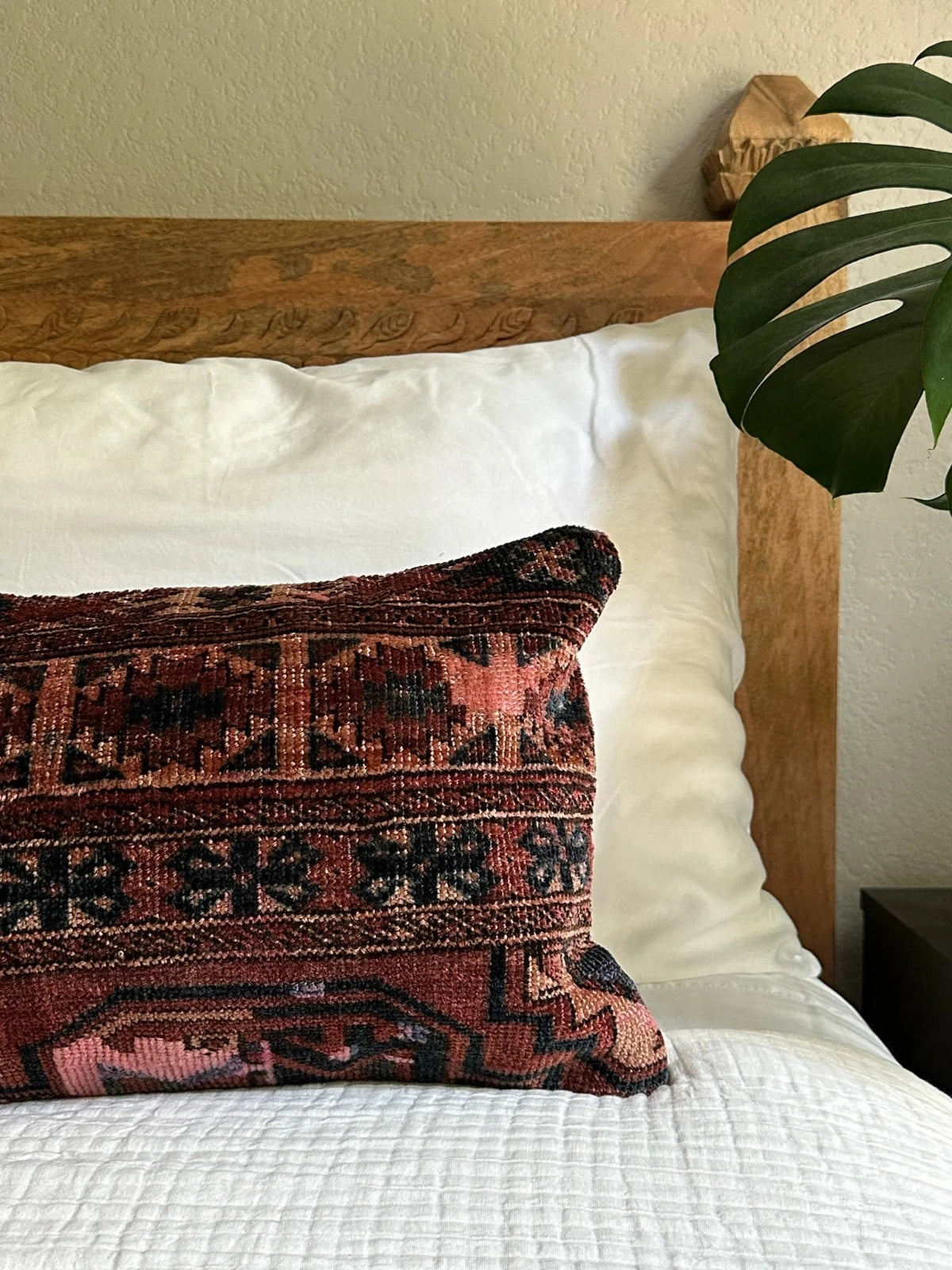 12 by 24 inch handmade Turkish lumbar pillows featuring a velvety soft pile and merlot red, pink and navy color palette.