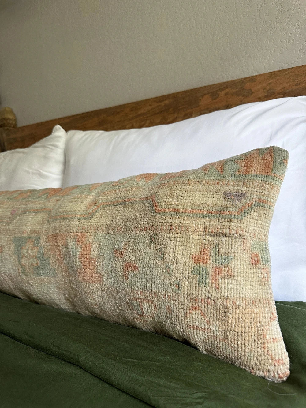 12 by 36 handmade Turkish lumbar pillow featuring floral and geometric designs and salmon, teal and sand coloring