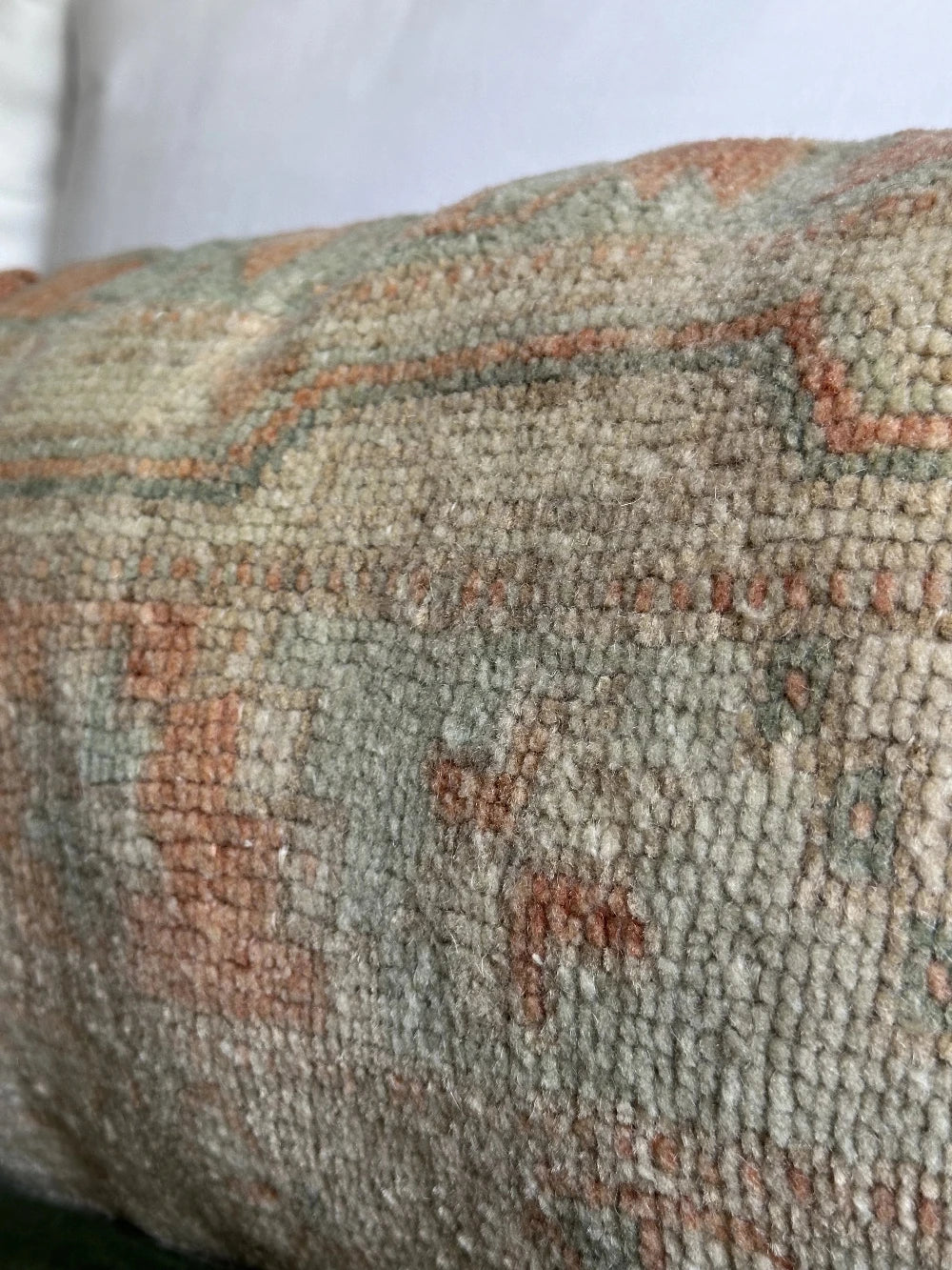 12 by 36 handmade Turkish lumbar pillow featuring floral and geometric designs and salmon, teal and sand coloring