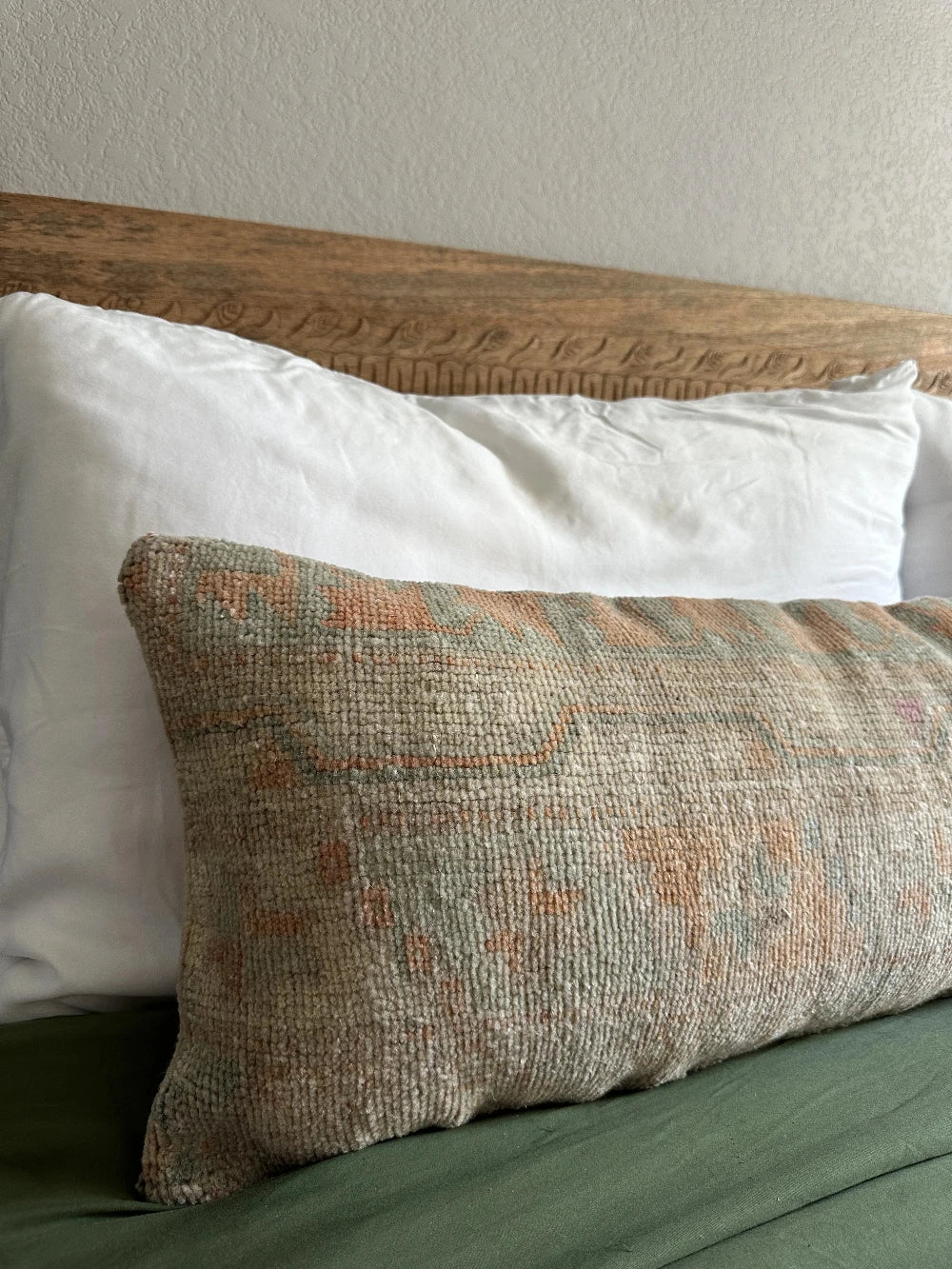12 by 36 handmade Turkish lumbar pillow featuring floral and geometric designs and salmon, teal and sand coloring